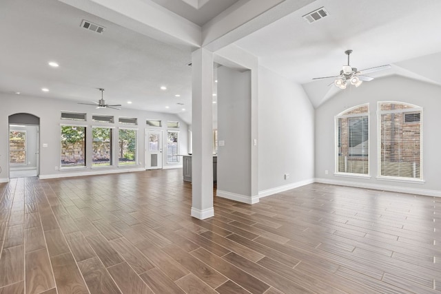 3604 Mercer Rd, Georgetown, TX 78628 - unfurnished living room with a ceiling fan, recessed lighting, dark wood-style flooring, vaulted ceiling, and arched walkways