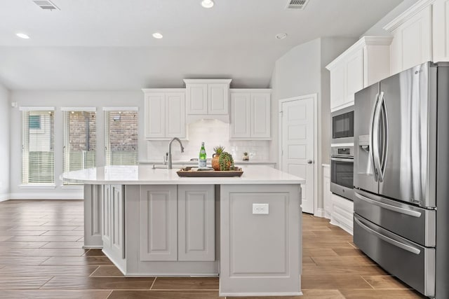 3604 Mercer Rd, Georgetown, TX 78628 - kitchen featuring stainless steel appliances, light countertops, white cabinets, recessed lighting, and tasteful backsplash
