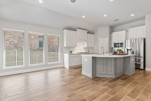 3604 Mercer Rd, Georgetown, TX 78628 - kitchen with stainless steel fridge, built in microwave, light countertops, white cabinets, and cooktop