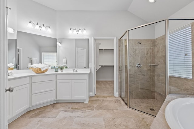 3604 Mercer Rd, Georgetown, TX 78628 - bathroom featuring a stall shower, vaulted ceiling, double vanity, a bath, and a spacious closet