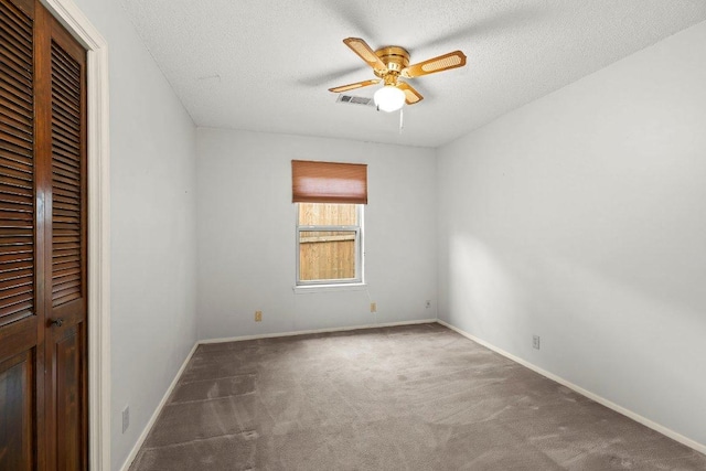 2403 N Shields Dr, Austin, TX 78727 - unfurnished bedroom featuring carpet floors, a closet, a textured ceiling, and ceiling fan