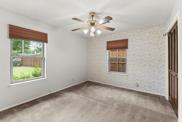 2403 N Shields Dr, Austin, TX 78727 - carpeted spare room with a ceiling fan and a textured ceiling