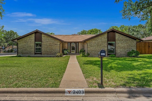 2403 N Shields Dr, Austin, TX 78727 - mid-century home featuring a front yard and brick siding
