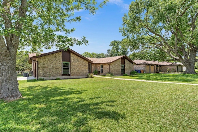 2403 N Shields Dr, Austin, TX 78727 - mid-century modern home featuring a front lawn and brick siding