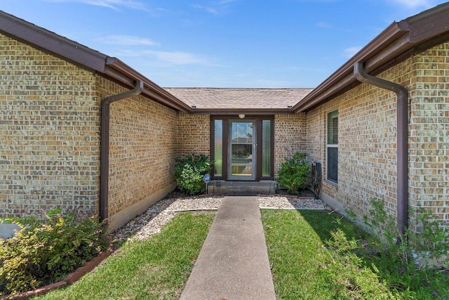 2403 N Shields Dr, Austin, TX 78727 - doorway to property with brick siding and a shingled roof