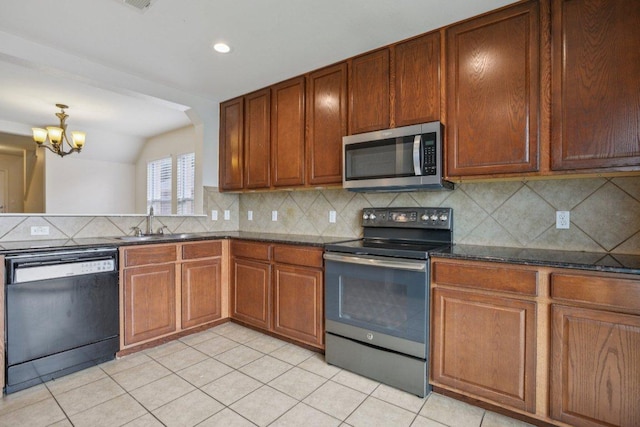 13413 Lismore Ln, Pflugerville, TX 78660 - kitchen featuring stainless steel microwave, range with electric stovetop, dishwasher, light tile patterned floors, and decorative backsplash