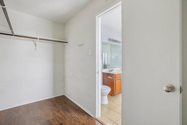 13413 Lismore Ln, Pflugerville, TX 78660 - walk in closet with wood finished floors and a sink