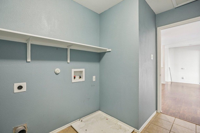 13413 Lismore Ln, Pflugerville, TX 78660 - laundry room featuring washer hookup, hookup for an electric dryer, tile patterned floors, hookup for a gas dryer, and a textured wall