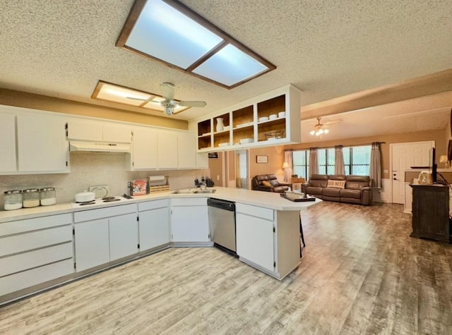 702 Pleasant Grove Rd, Elgin, TX 78621 - kitchen featuring stainless steel dishwasher, a ceiling fan, a textured ceiling, under cabinet range hood, and a peninsula
