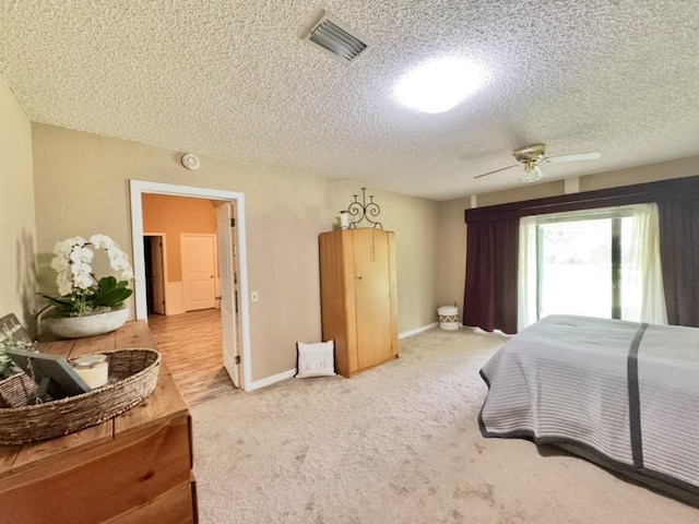 702 Pleasant Grove Rd, Elgin, TX 78621 - bedroom with a textured ceiling and light colored carpet