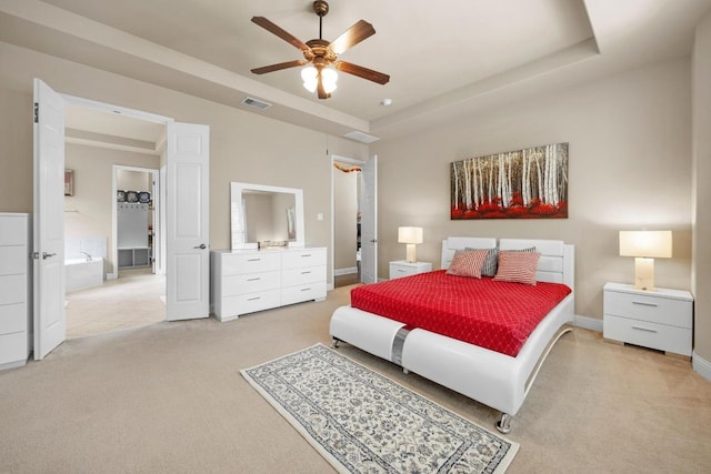 14405 Laurinburg Dr, Austin, TX 78717 - bedroom featuring light colored carpet, a tray ceiling, and a ceiling fan