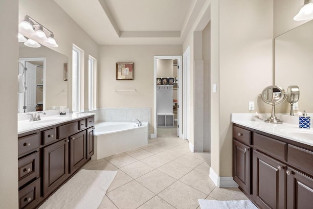 14405 Laurinburg Dr, Austin, TX 78717 - bathroom featuring two vanities, tile patterned flooring, a bath, and a spacious closet