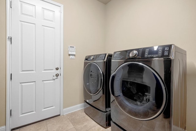 14405 Laurinburg Dr, Austin, TX 78717 - laundry room with washer and clothes dryer and light tile patterned flooring