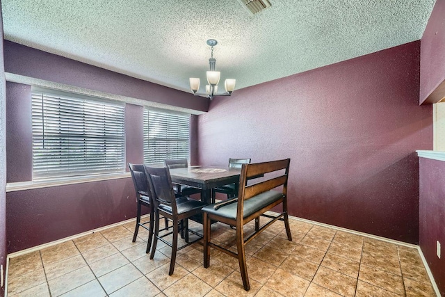 14305 Vandever St, Austin, TX 78725 - tiled dining space featuring a chandelier, a textured ceiling, and a textured wall
