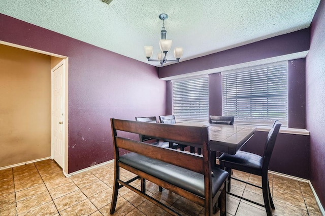 14305 Vandever St, Austin, TX 78725 - dining room with a chandelier, a textured ceiling, and light tile patterned flooring