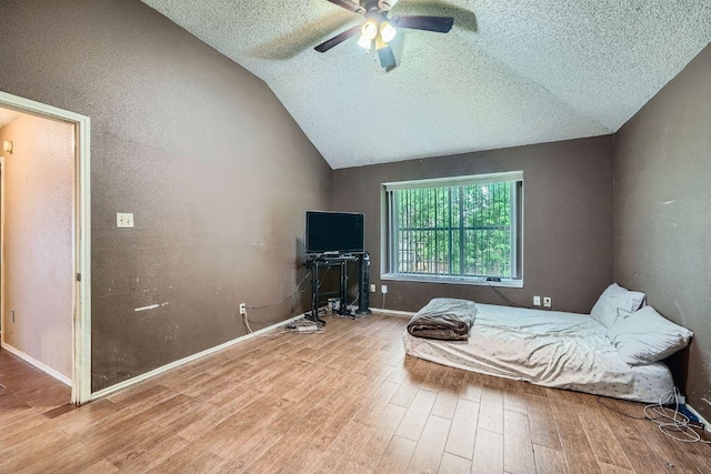 14305 Vandever St, Austin, TX 78725 - bedroom featuring wood finished floors, a textured ceiling, vaulted ceiling, and ceiling fan