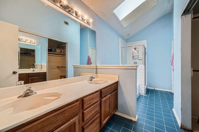 14305 Vandever St, Austin, TX 78725 - full bath featuring a skylight, lofted ceiling, a shower stall, tile patterned floors, and double vanity
