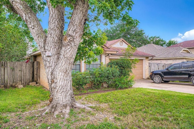 14305 Vandever St, Austin, TX 78725 - view of front of property with a garage, concrete driveway, brick siding, and roof with shingles