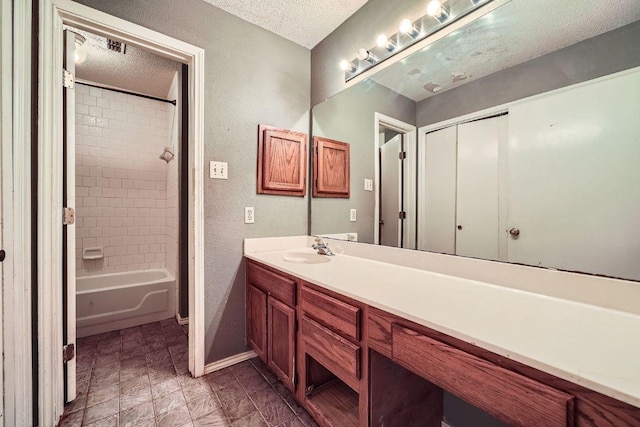 14305 Vandever St, Austin, TX 78725 - full bath with vanity, a textured ceiling, bathtub / shower combination, and a textured wall