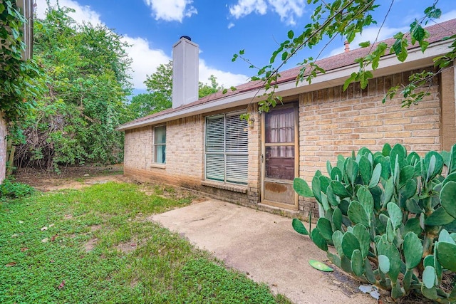 14305 Vandever St, Austin, TX 78725 - doorway to property featuring brick siding and a chimney