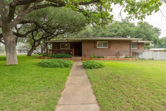 507 Flamingo Cir, Marble Falls, TX 78654 - ranch-style house with brick siding and a porch