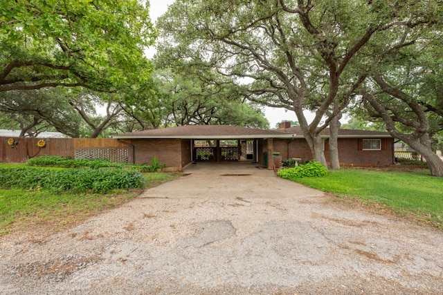 507 Flamingo Cir, Marble Falls, TX 78654 - ranch-style home featuring driveway, brick siding, a chimney, and an attached carport