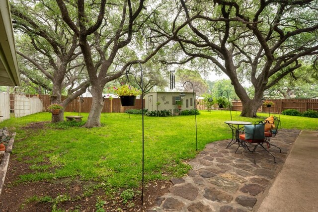 507 Flamingo Cir, Marble Falls, TX 78654 - fenced backyard with a patio and outdoor dining space