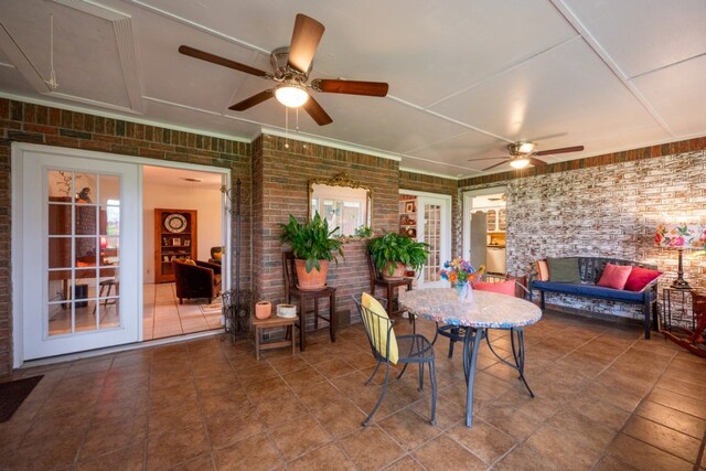 507 Flamingo Cir, Marble Falls, TX 78654 - dining space with brick wall, a ceiling fan, and tile patterned flooring
