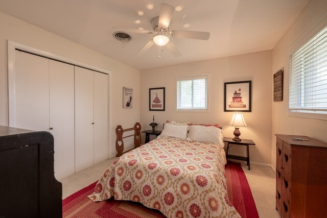 507 Flamingo Cir, Marble Falls, TX 78654 - bedroom featuring light colored carpet, a closet, and ceiling fan