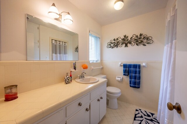 507 Flamingo Cir, Marble Falls, TX 78654 - bathroom with vanity, a wainscoted wall, tile patterned floors, and tile walls