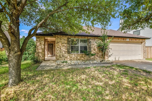 301 Wildwood Dr, Georgetown, TX 78633 - view of front facade featuring an attached garage, concrete driveway, brick siding, roof with shingles, and a front yard
