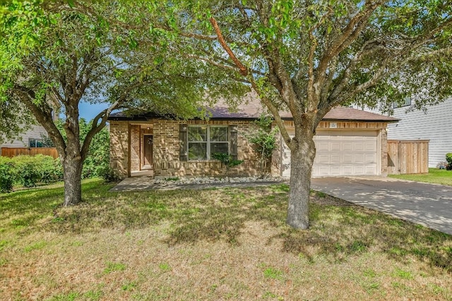 301 Wildwood Dr, Georgetown, TX 78633 - view of front facade featuring a garage, driveway, and brick siding