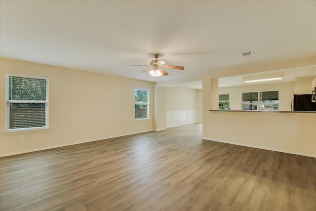 301 Wildwood Dr, Georgetown, TX 78633 - unfurnished living room with wood finished floors and ceiling fan