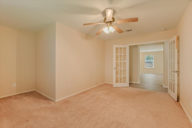 301 Wildwood Dr, Georgetown, TX 78633 - empty room with french doors, light carpet, and ceiling fan