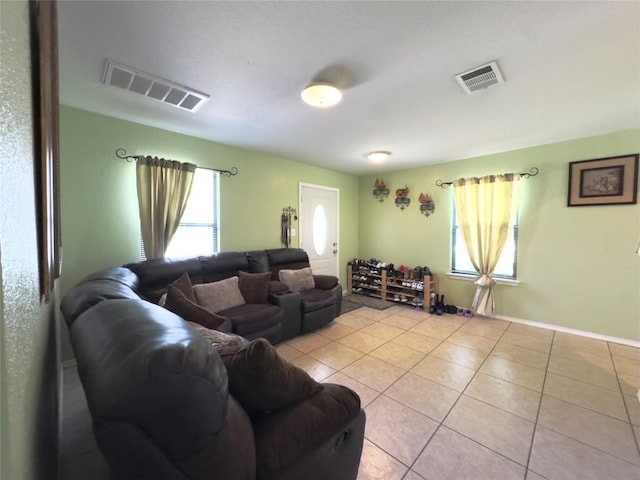 551 Abundance Ln, Kyle, TX 78640 - living area featuring light tile patterned floors and baseboards