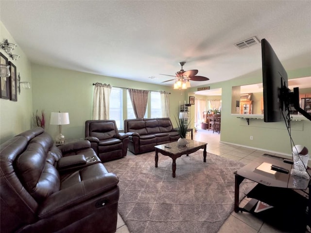551 Abundance Ln, Kyle, TX 78640 - tiled living room featuring ceiling fan and a textured ceiling