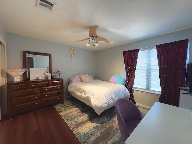 551 Abundance Ln, Kyle, TX 78640 - bedroom featuring dark wood-style floors and a ceiling fan
