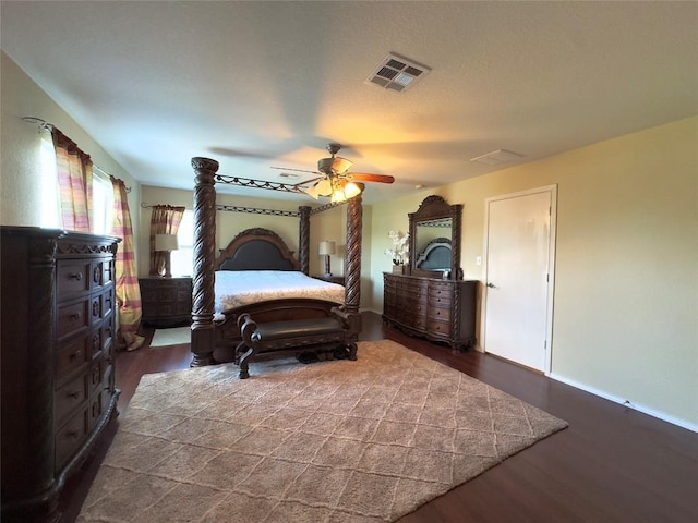 551 Abundance Ln, Kyle, TX 78640 - bedroom featuring dark wood finished floors and a ceiling fan