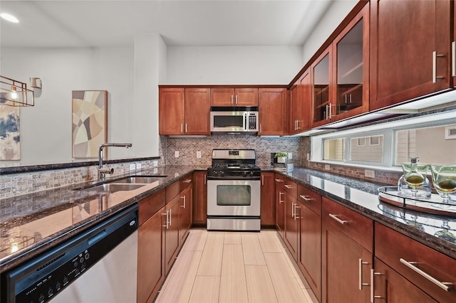 1115 Kinney Ave Unit 6, Austin, TX 78704 - kitchen with appliances with stainless steel finishes, dark stone countertops, and tasteful backsplash