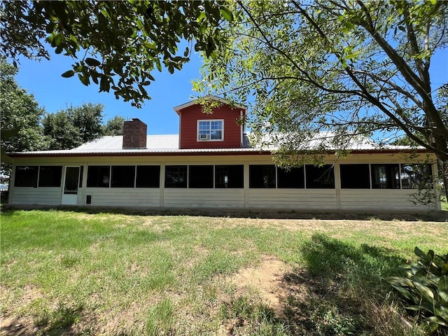 2120 Fm 1704, Elgin, TX 78621 - rear view of house featuring a sunroom, a yard, and a chimney