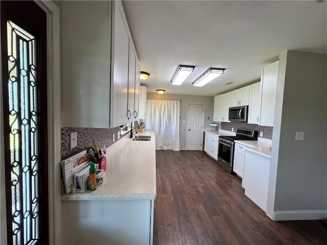 2120 Fm 1704, Elgin, TX 78621 - kitchen featuring appliances with stainless steel finishes, decorative backsplash, dark wood-style floors, and white cabinetry