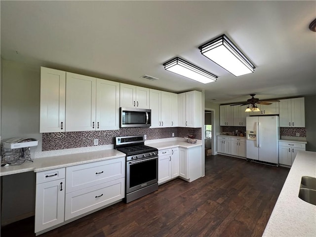 2120 Fm 1704, Elgin, TX 78621 - kitchen with stainless steel appliances, backsplash, light countertops, dark wood-type flooring, and a ceiling fan