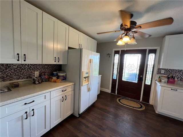 2120 Fm 1704, Elgin, TX 78621 - kitchen featuring white fridge with ice dispenser, backsplash, light countertops, and white cabinetry