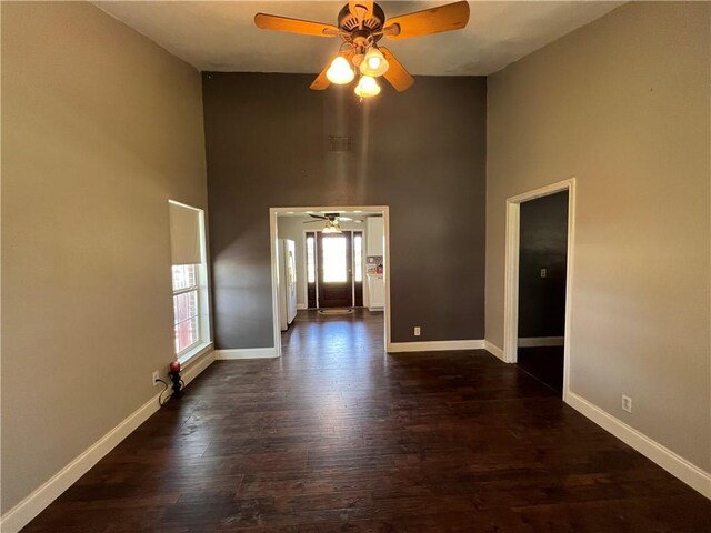 2120 Fm 1704, Elgin, TX 78621 - unfurnished room with a ceiling fan, a high ceiling, and dark wood-style flooring