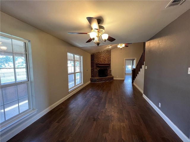 2120 Fm 1704, Elgin, TX 78621 - unfurnished living room featuring dark wood-style floors, ceiling fan, a fireplace, lofted ceiling, and stairs