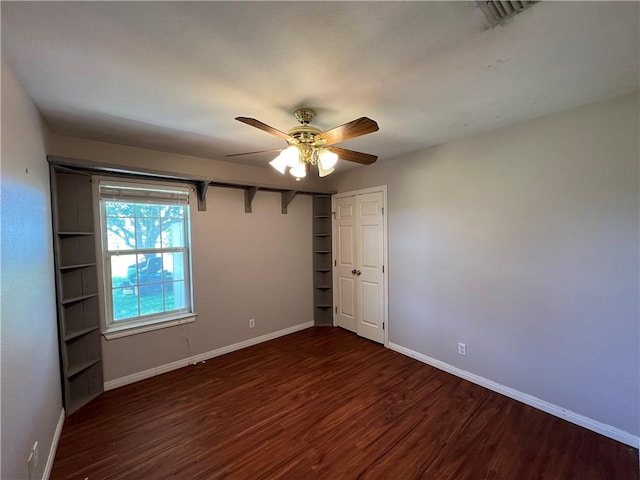 2120 Fm 1704, Elgin, TX 78621 - unfurnished bedroom with wood finished floors, a closet, and a ceiling fan