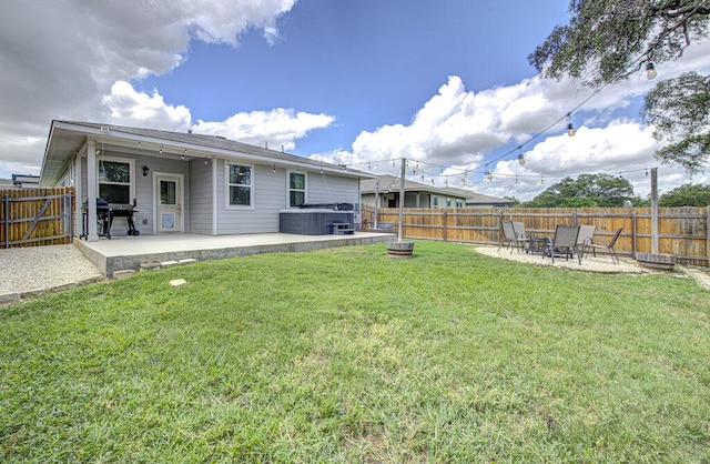 261 Deserti Rd, Leander, TX 78641 - rear view of house with a hot tub, a patio area, and a fenced backyard