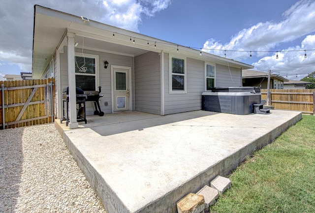 261 Deserti Rd, Leander, TX 78641 - rear view of house with a hot tub and a patio