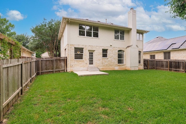 15213 Mallard Green Ln, Austin, TX 78728 - back of property featuring entry steps, a chimney, a fenced backyard, stucco siding, and a patio area