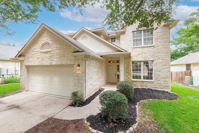 15213 Mallard Green Ln, Austin, TX 78728 - view of front facade with stone siding, an attached garage, and concrete driveway